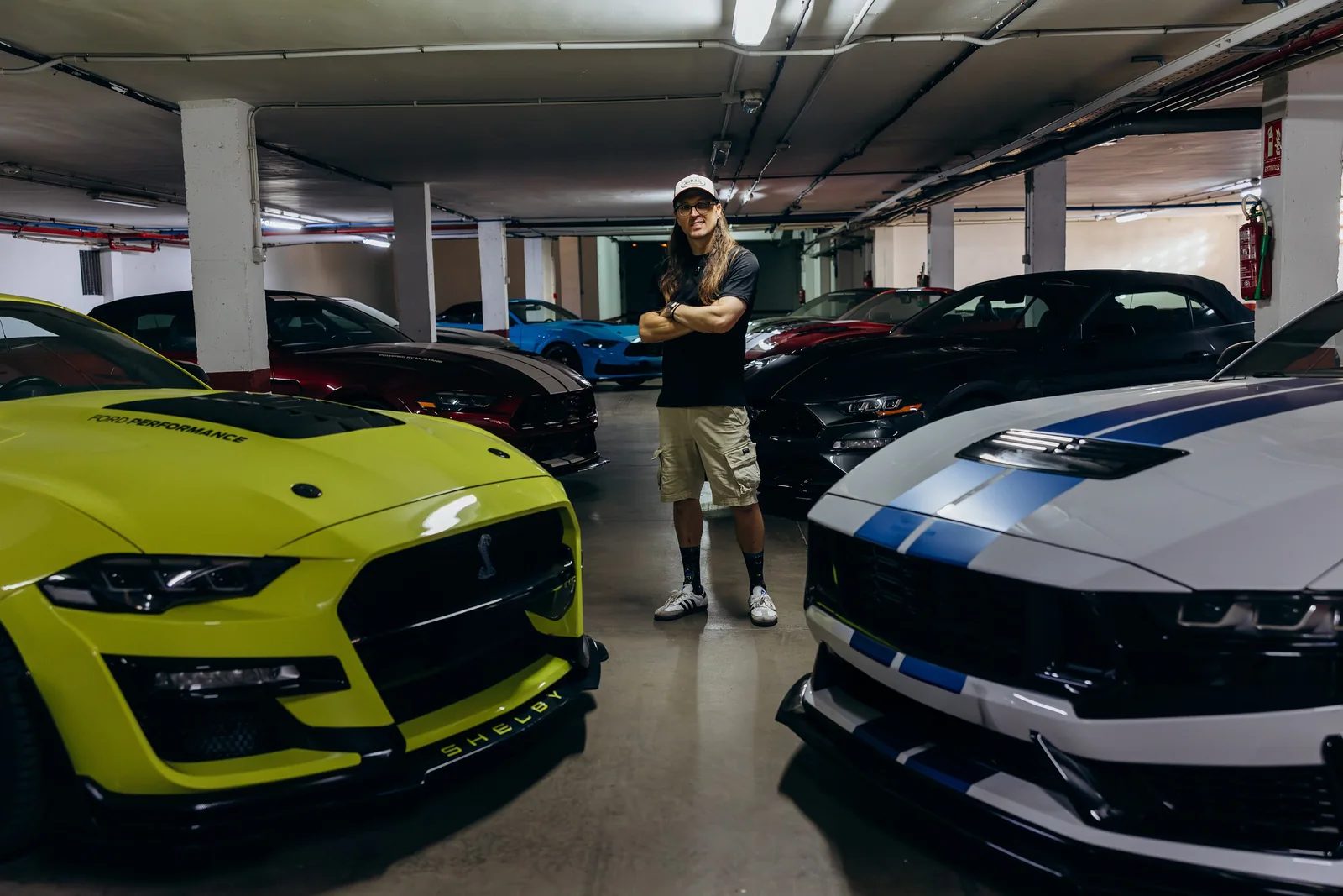 Iván Mora, founder of Canary Islands Luxury Cars, with the Mustang fleet